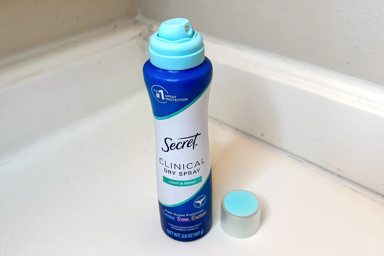 The Secret Clinical Strength Dry Spray Antiperspirant Deodorant with the cap off