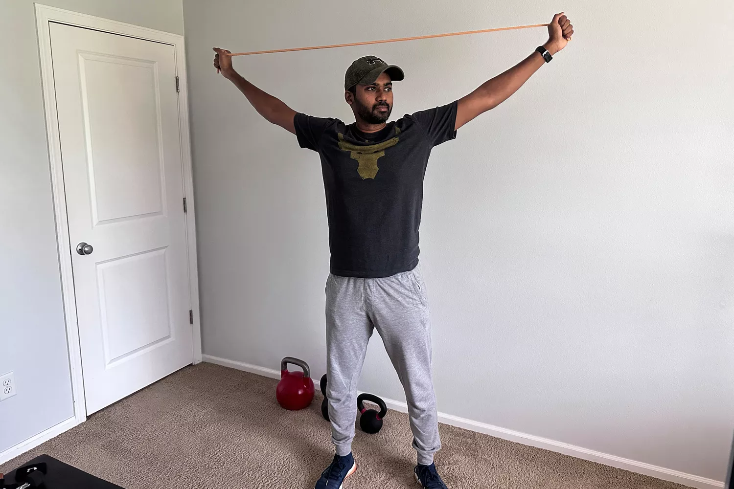 A person stretching a Serious Steel 41 Heavy Duty Resistance Band over their head
