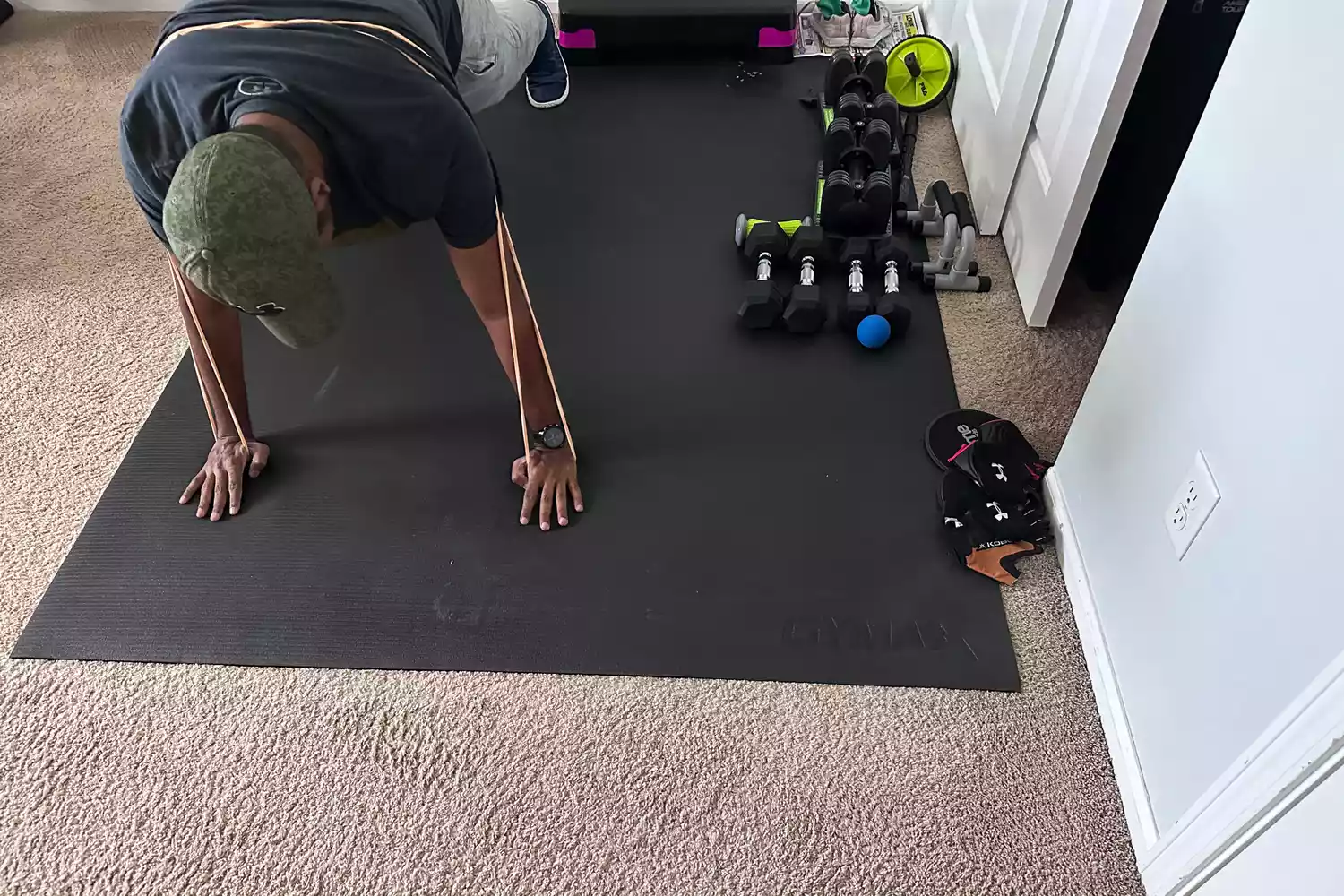 A person wearing a Serious Steel 41 Heavy Duty Resistance Band while doing pushups on the floor