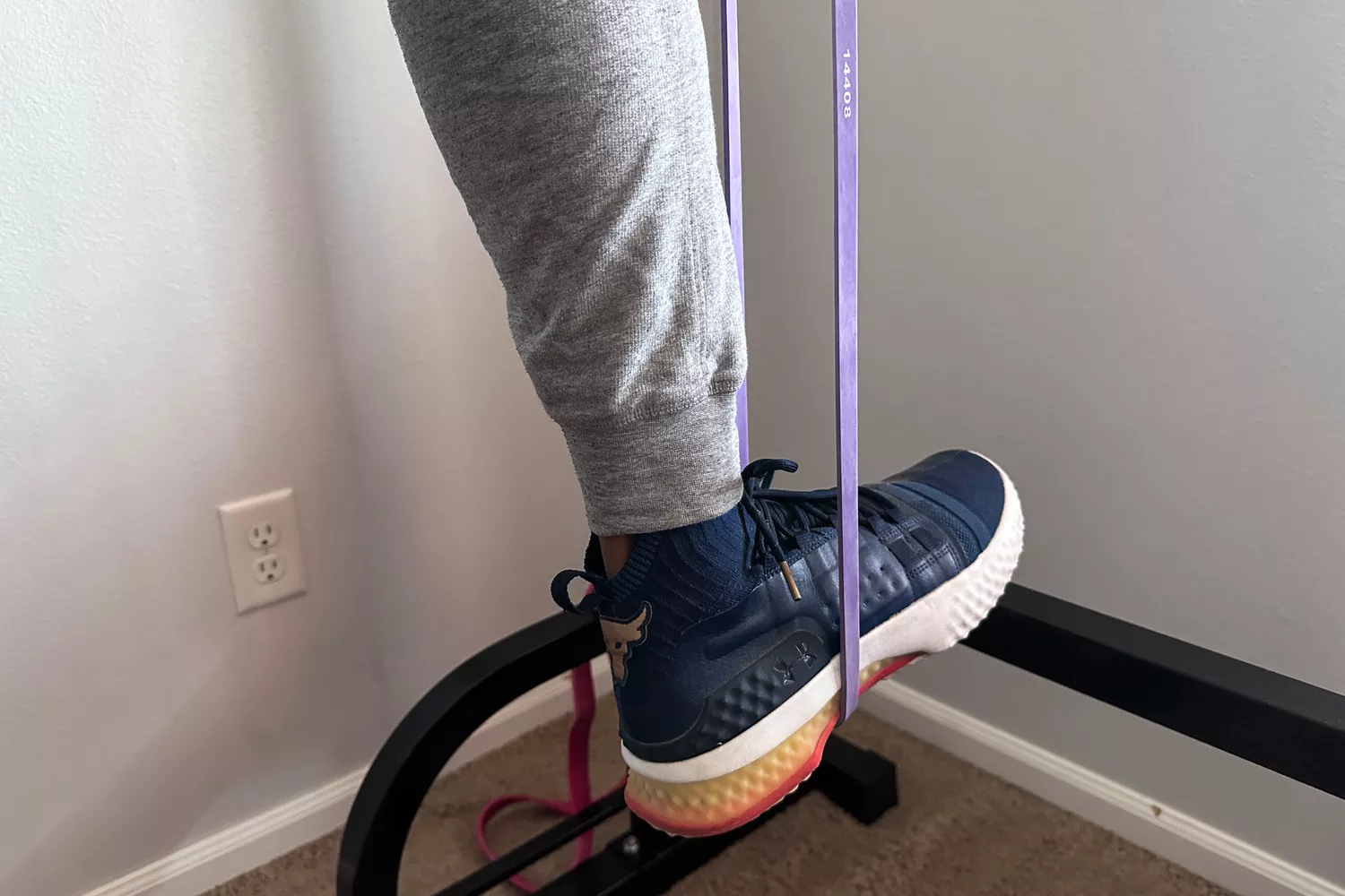 A foot stepping on a purple Serious Steel 41 Heavy Duty Resistance Band