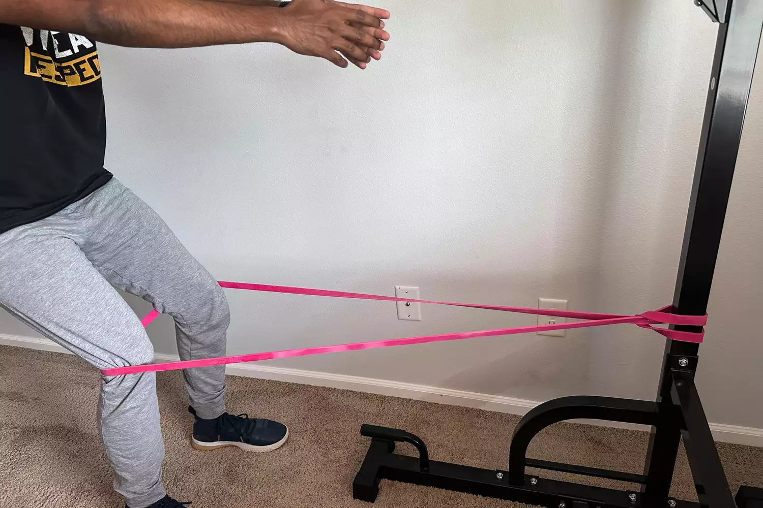 A person using the Serious Steel 41 Heavy Duty Resistance Bands wrapped around a metal pole