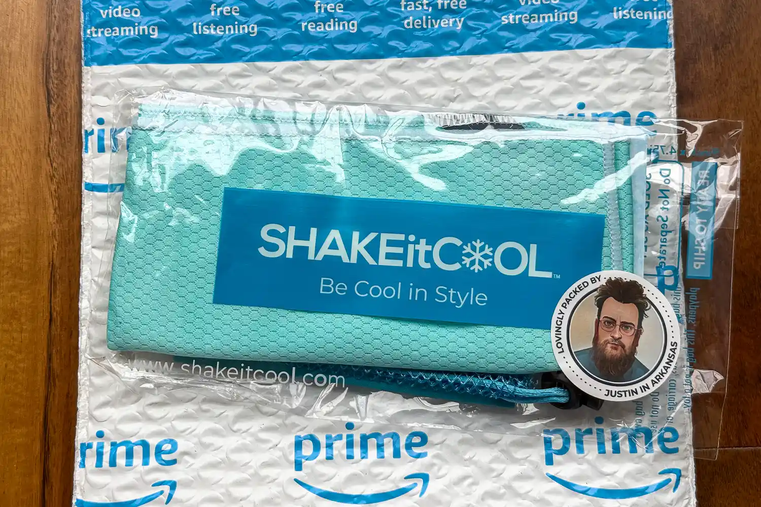 The SHAKEitCOOL Original Cooling Towel inside plastic packaging