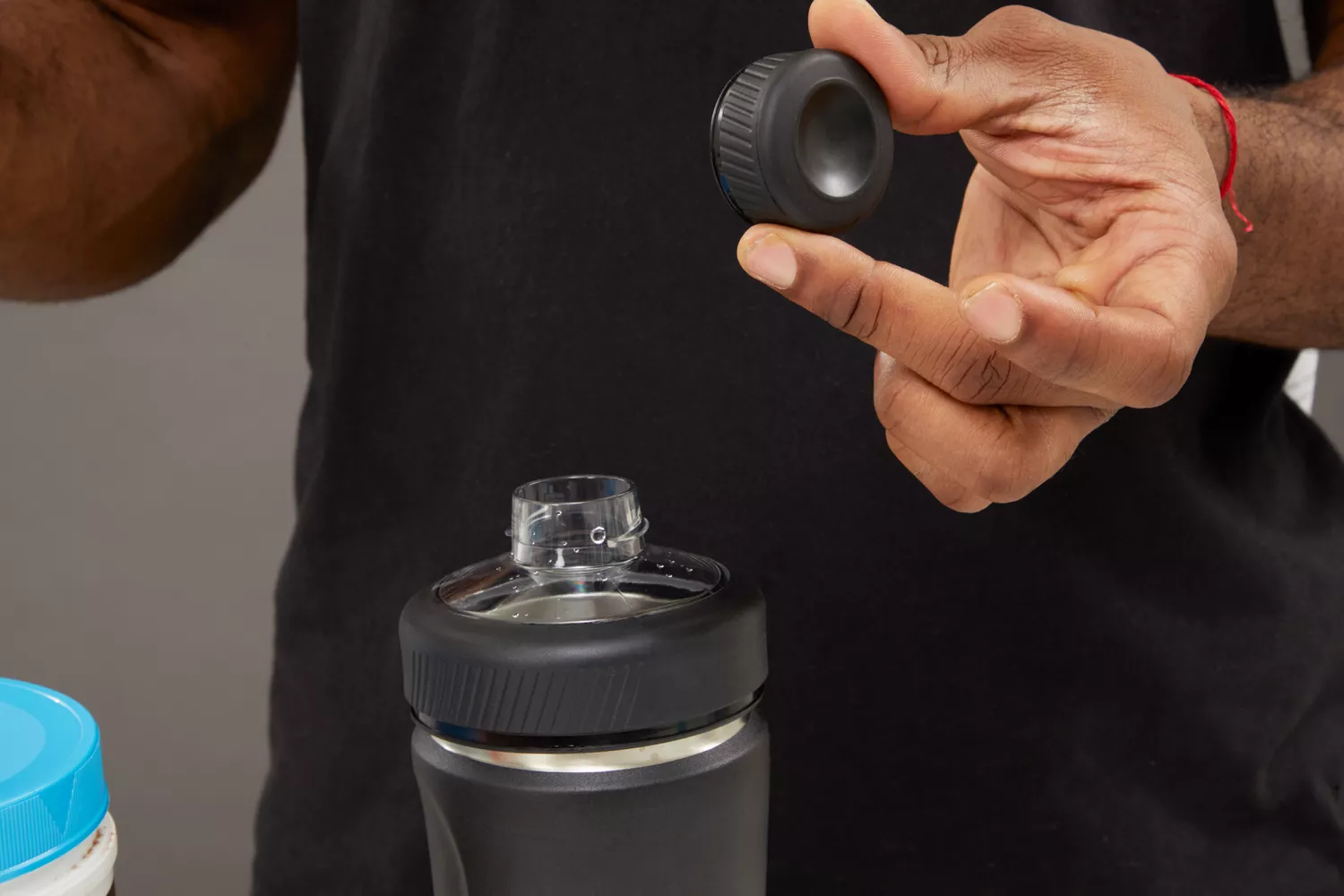 Person holding BlenderBottle Radian 26 oz Shaker Cup cap