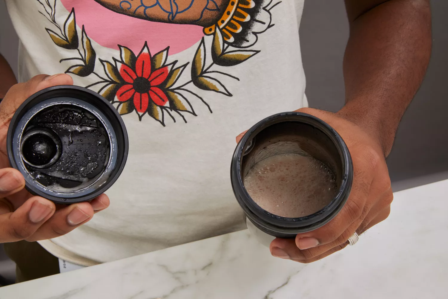 Person holding BlenderBottle SportMixer Tritan Grip Shaker Bottle with drink