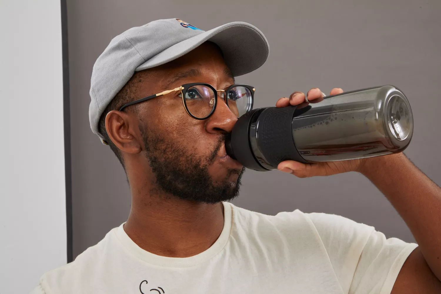 Person drinking from BlenderBottle SportMixer Tritan Grip Shaker Bottle