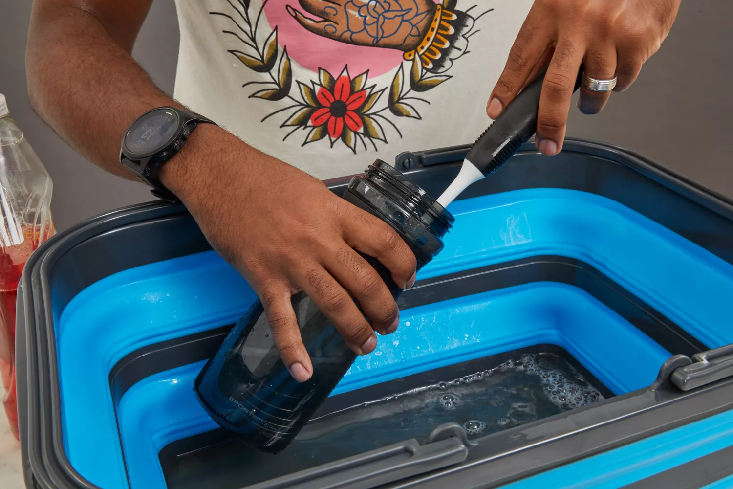 Person cleaning BlenderBottle SportMixer Tritan Grip Shaker Bottle