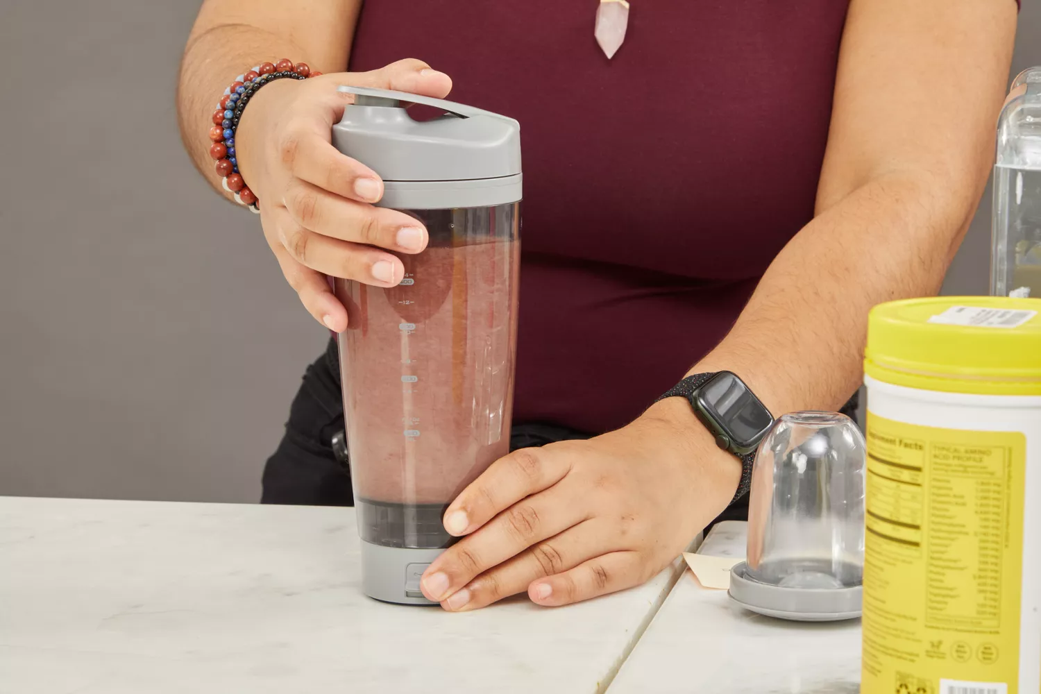 Person holding PROMiXX Pro Shaker Rechargeable Bottle with drink