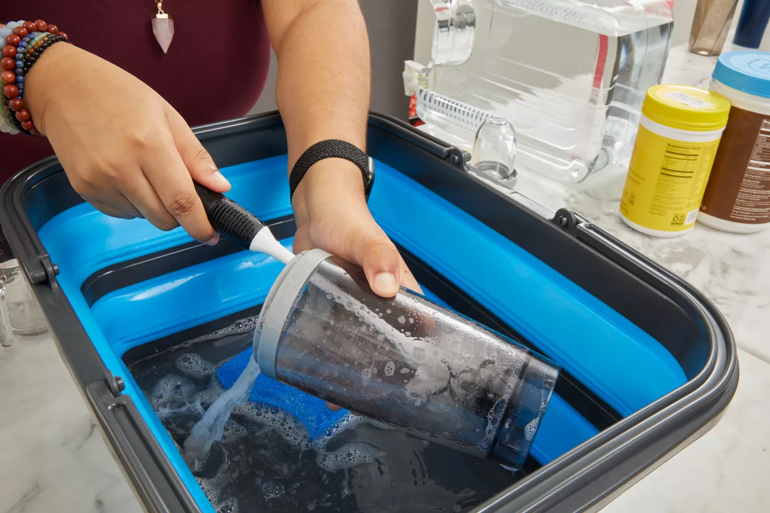 Person cleaning PROMiXX Pro Shaker Rechargeable Bottle