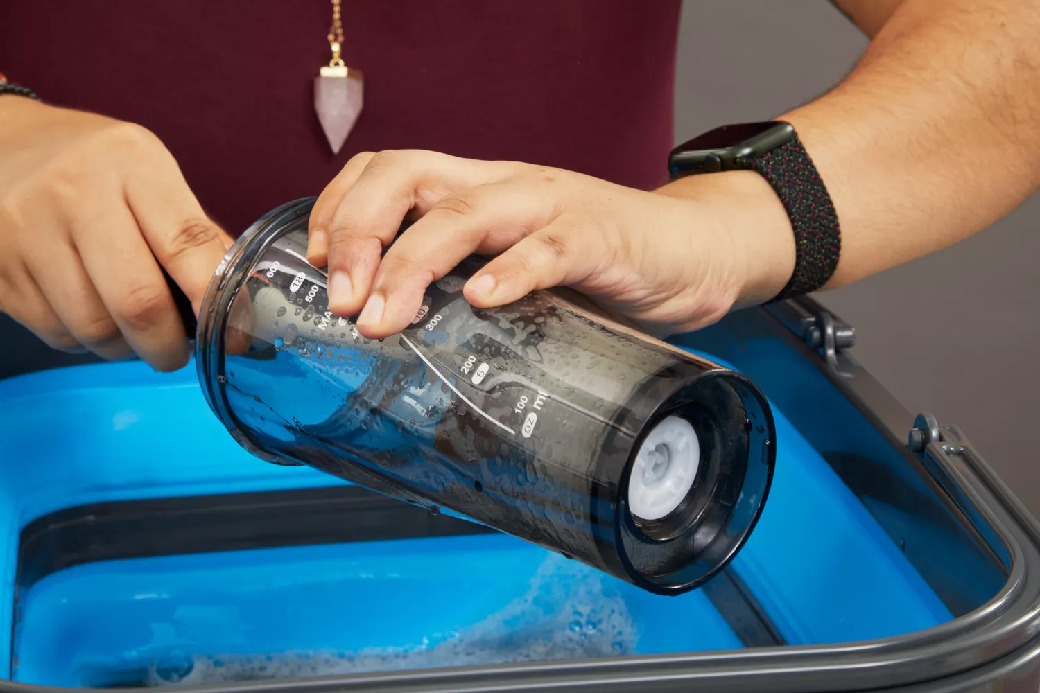 Person cleaning VOLTRX Premium Electric Protein Shaker Bottle