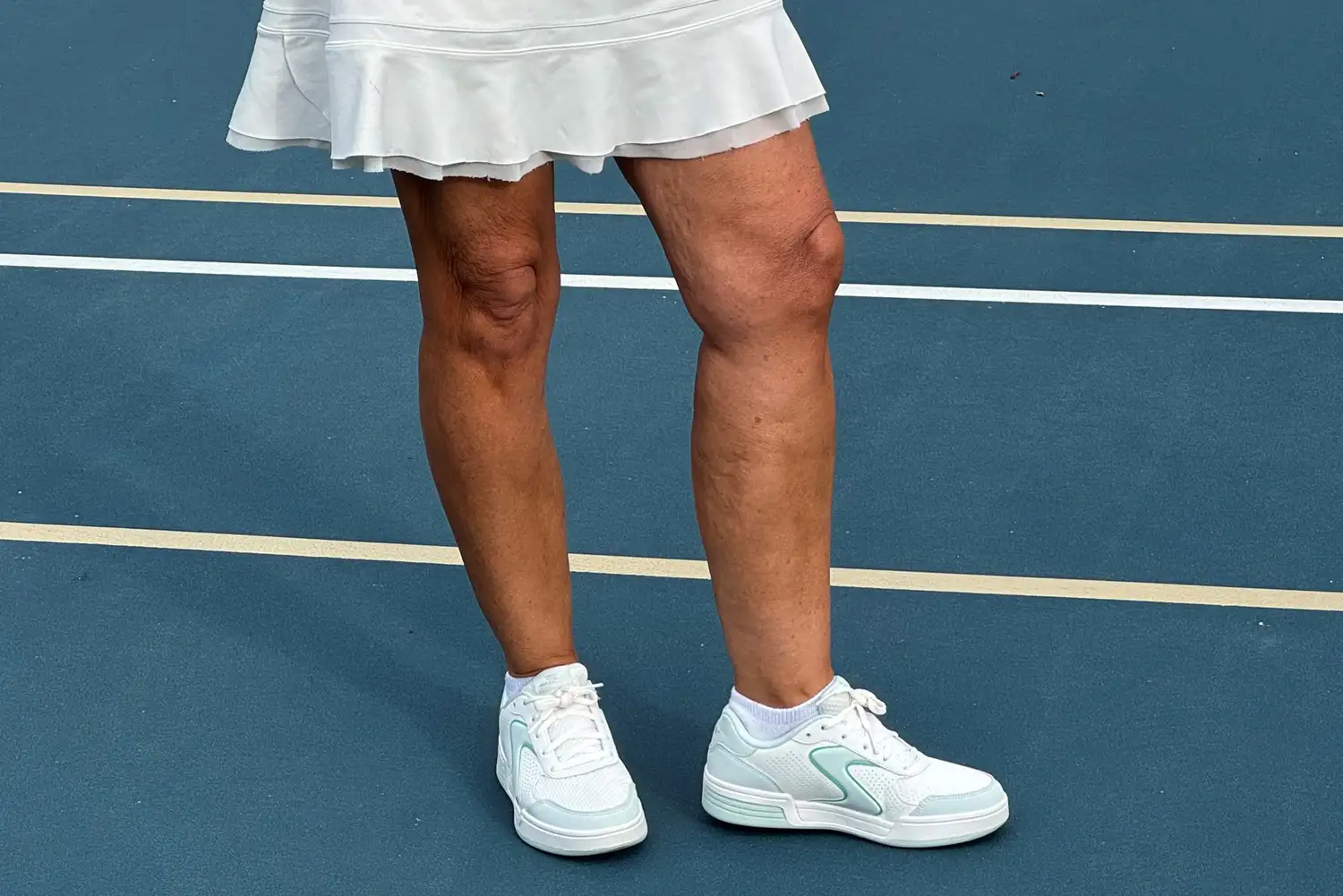 A person wearing the Skechers Women's Viper Court Classic Pickleball Shoes on a pickleball court