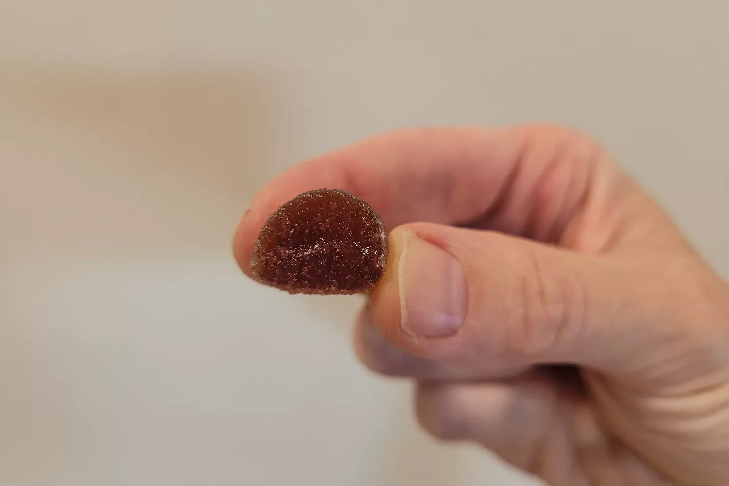 A person holds up a half eaten Skratch Labs Sport Energy Chew