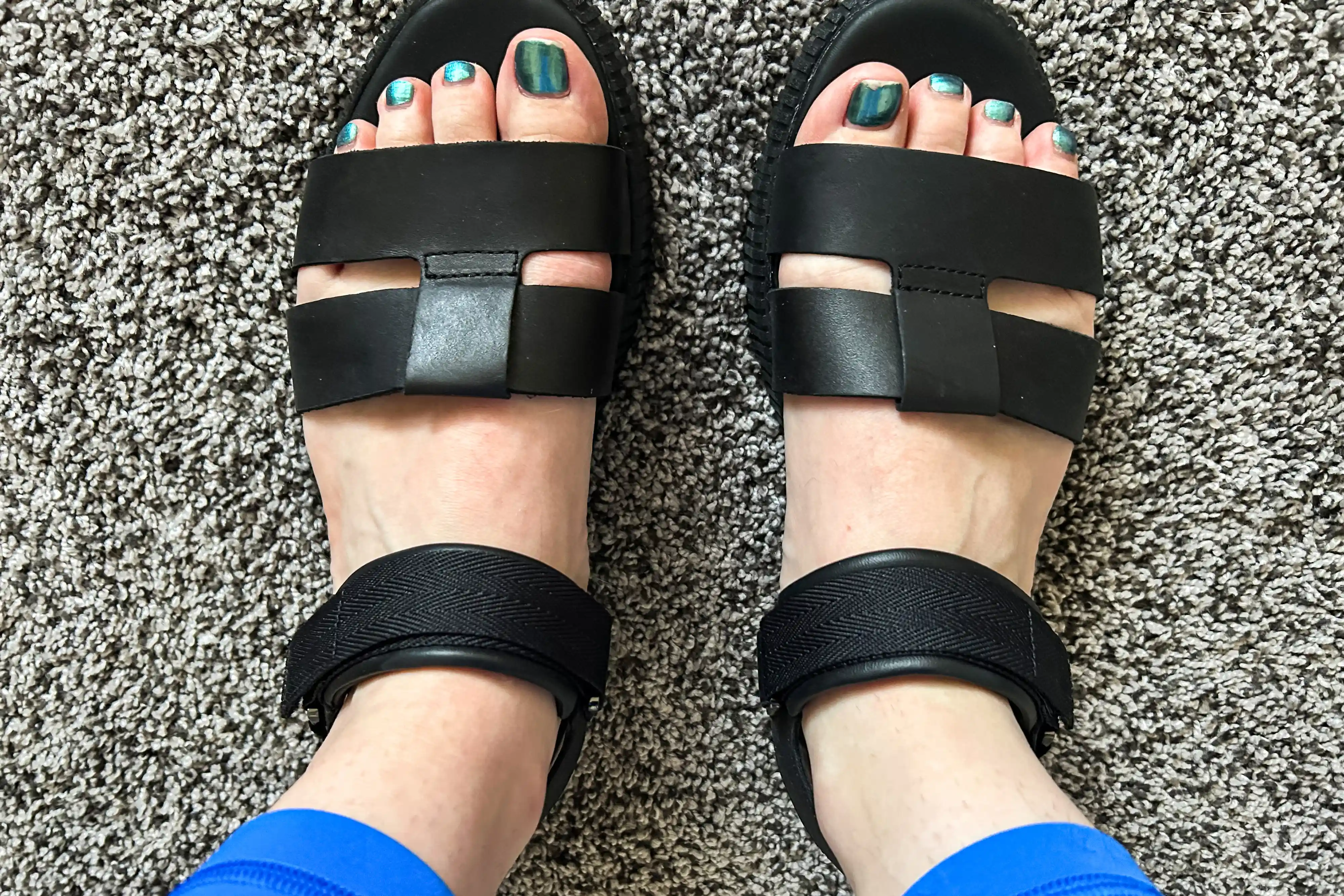 An overhead view of the Sorel ONA AVE Women's Ankle Strap Flat Sandal on carpet