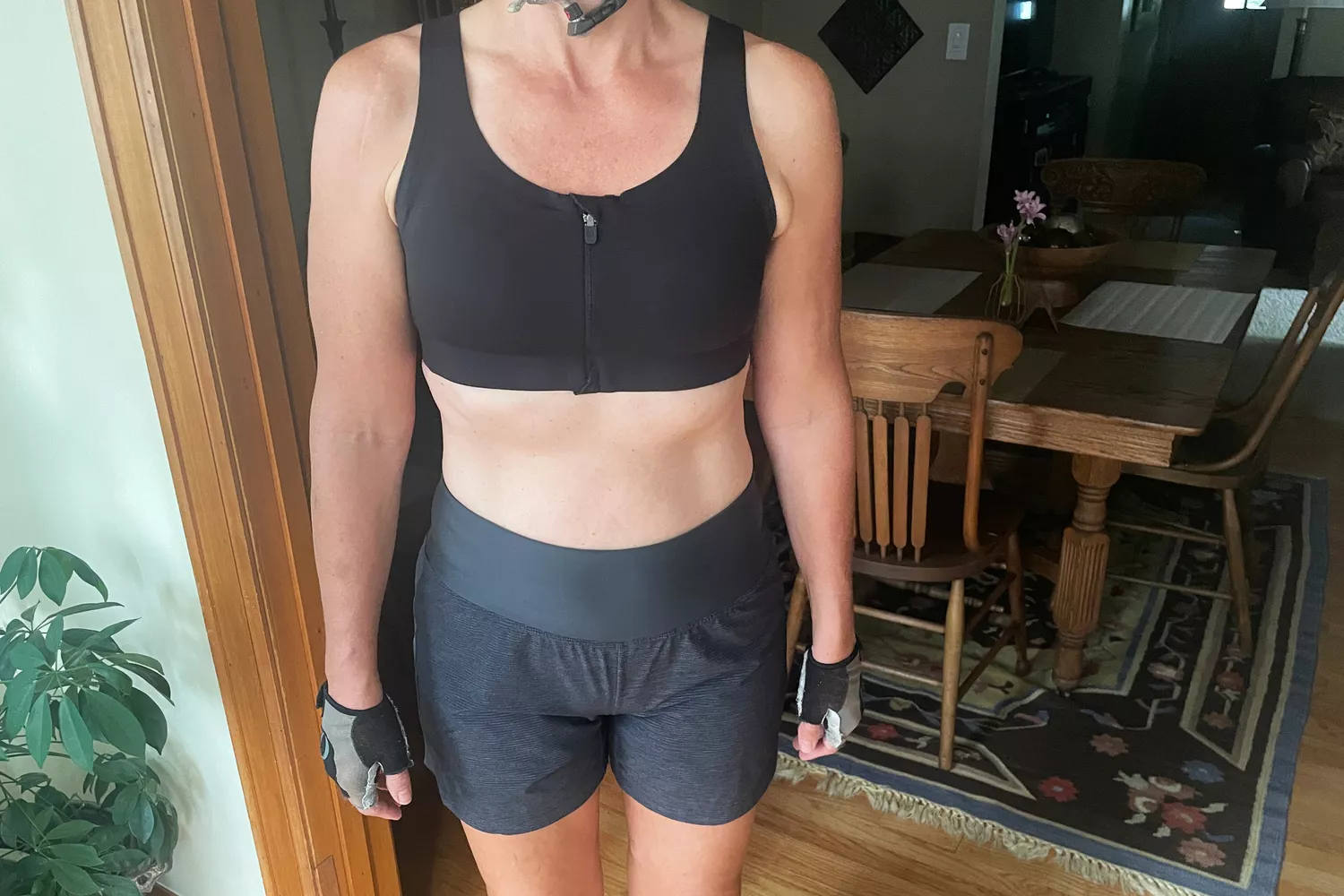 A person standing indoors wearing the lululemon Enlite Front Zip Bra High Support A-DDD Cups