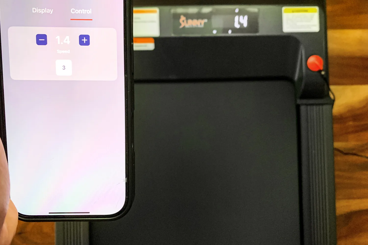 A smartphone app is used to control the Sunny Health & Fitness Treadpad 100 Smart Wi-Fi Connected Treadmill