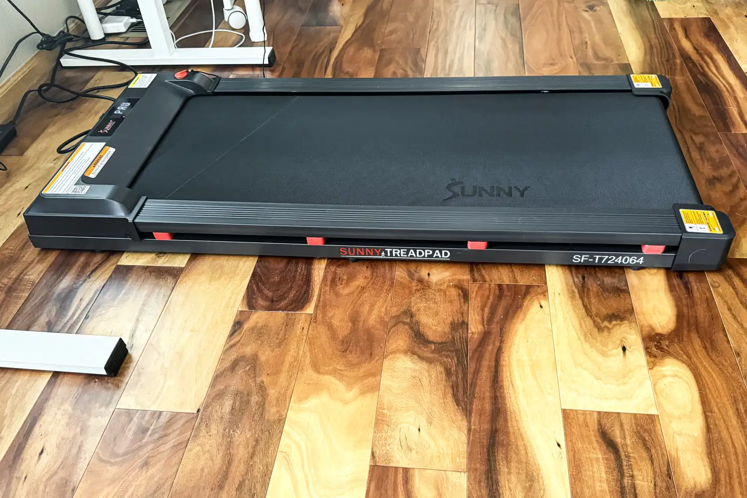 A side view of the Sunny Health & Fitness Treadpad 100 Smart Wi-Fi Connected Treadmill