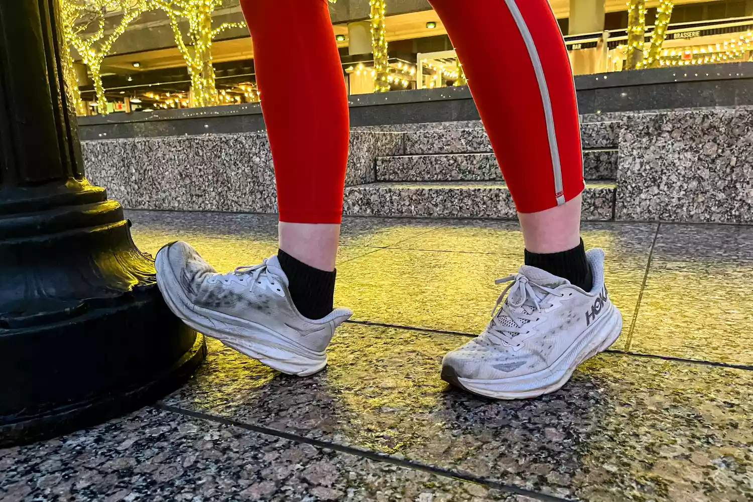A person wears sneakers containing the Superfeet All-Purpose Women's High Impact Support Insoles