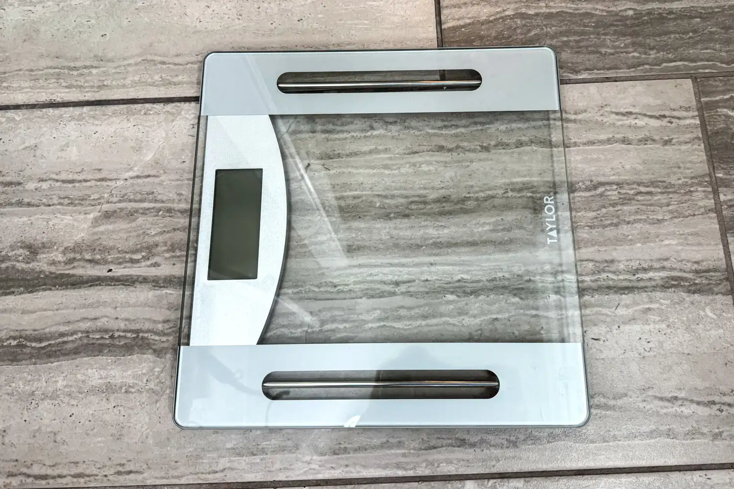 The Taylor Weight Tracking Smart Scale with Bluetooth Sync on a tile floor