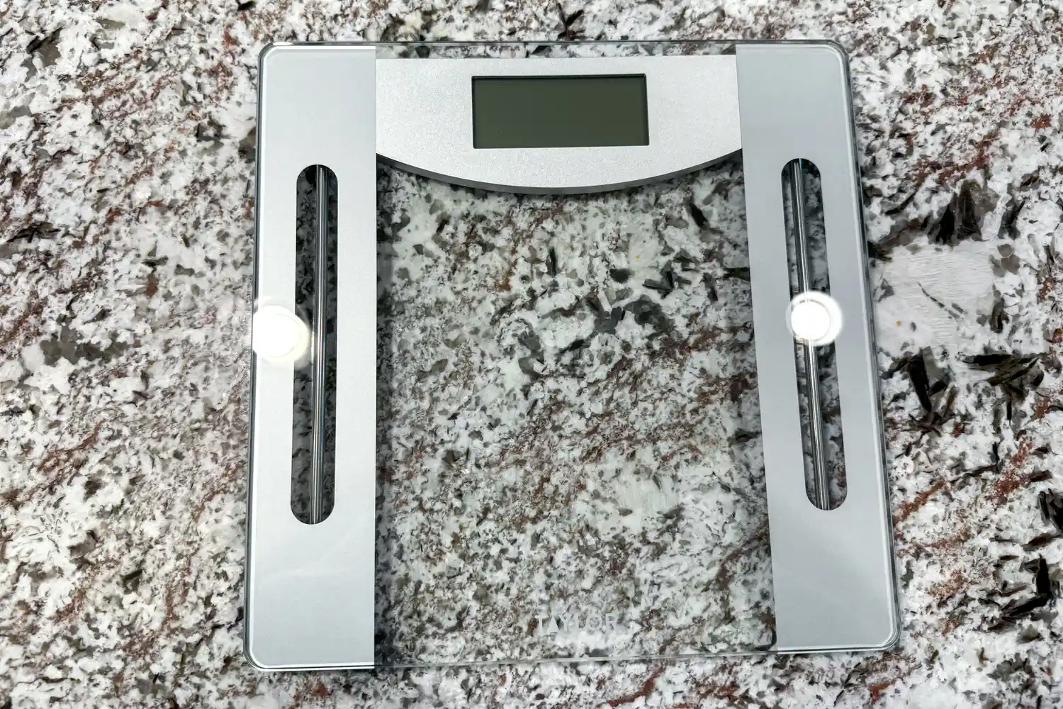 The Taylor Weight Tracking Smart Scale with Bluetooth Sync on a stone counter