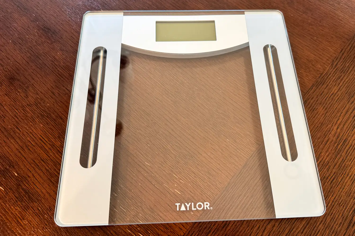 The Taylor Weight Tracking Smart Scale with Bluetooth Sync on a wooden floor