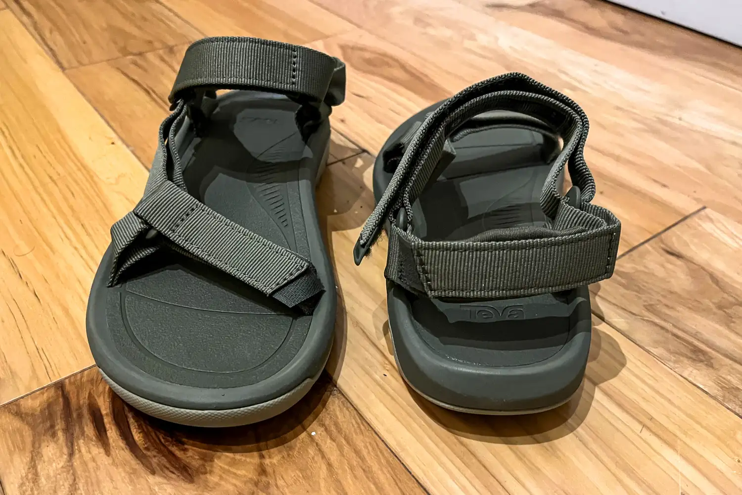 The Teva Women's Hurricane XLT2 sandals posed on wood