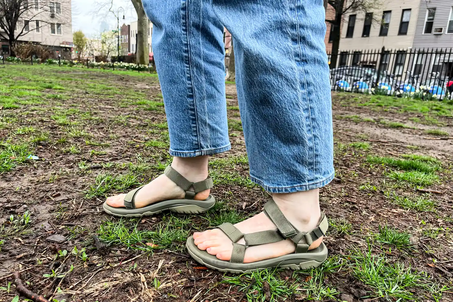 A person wearing the Teva Women's Hurricane XLT2 on dirt from a side view
