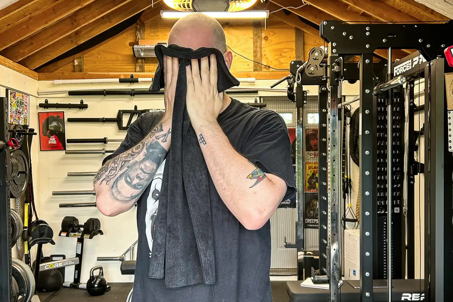 A person wipes their face with the The Rag Company Sport & Workout Towel