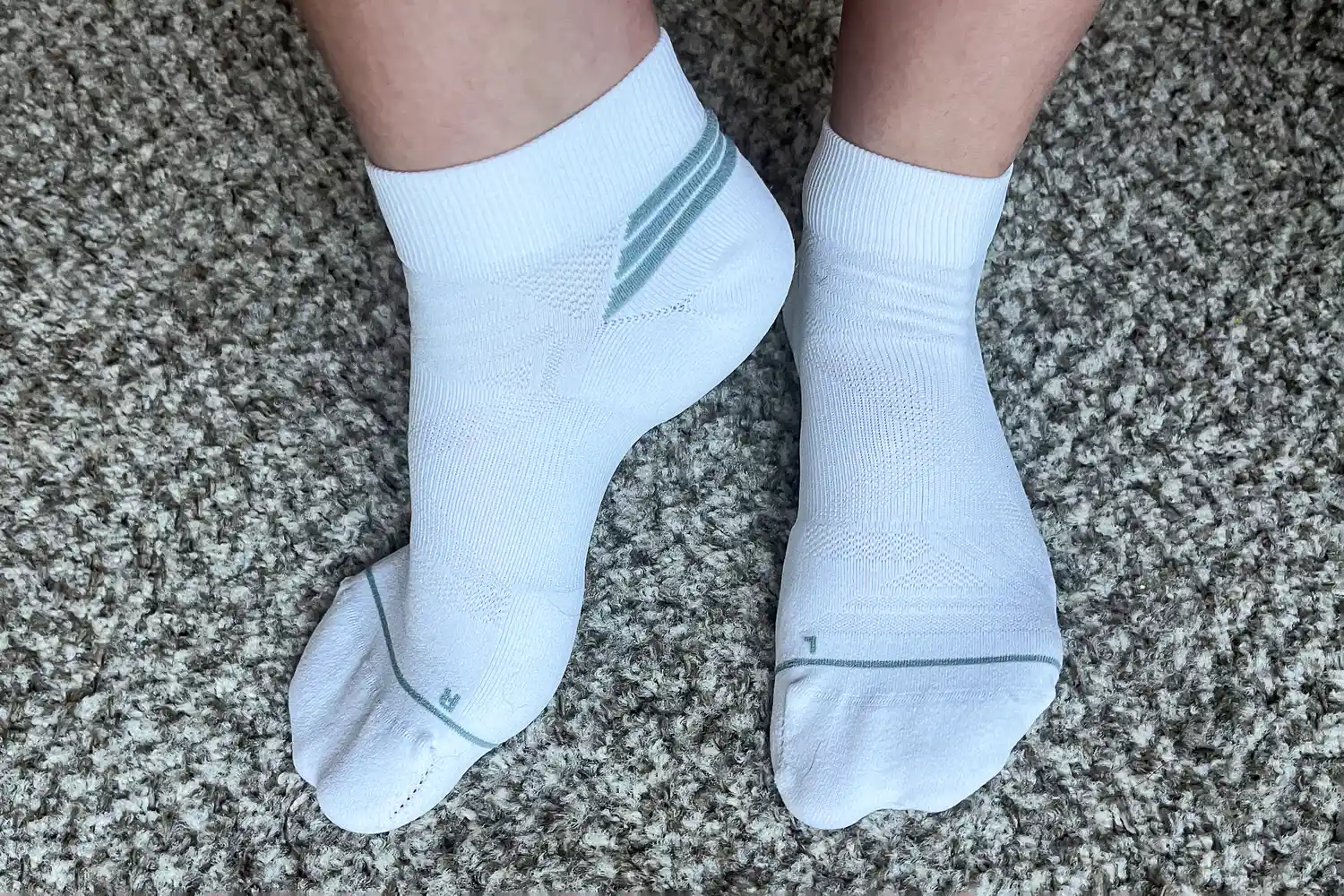 A person wears the Thorlo EXRUN003 Experia X SPEED Performance Cushion Ankle Socks
