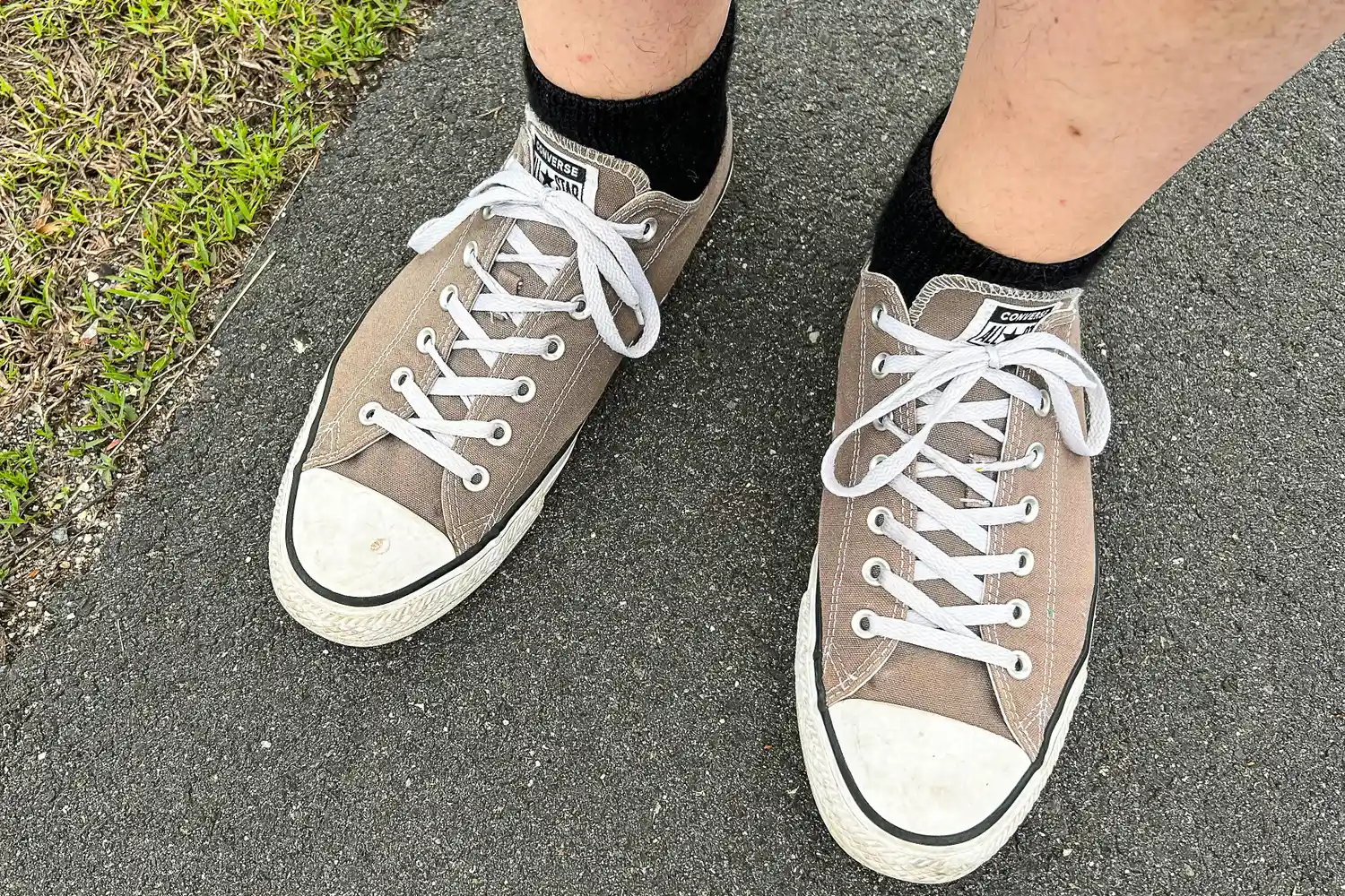 A person wears the Thorlo WMX Moderate Cushion Ankle Walking Socks under sneakers