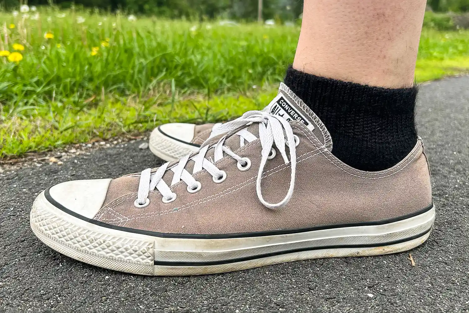 A person wears the Thorlo WMX Moderate Cushion Ankle Walking Socks in sneakers