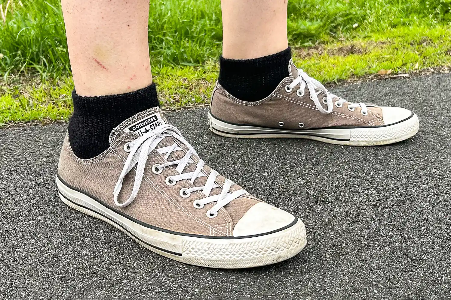 A person wears the Thorlo WMX Moderate Cushion Ankle Walking Socks while walking outside