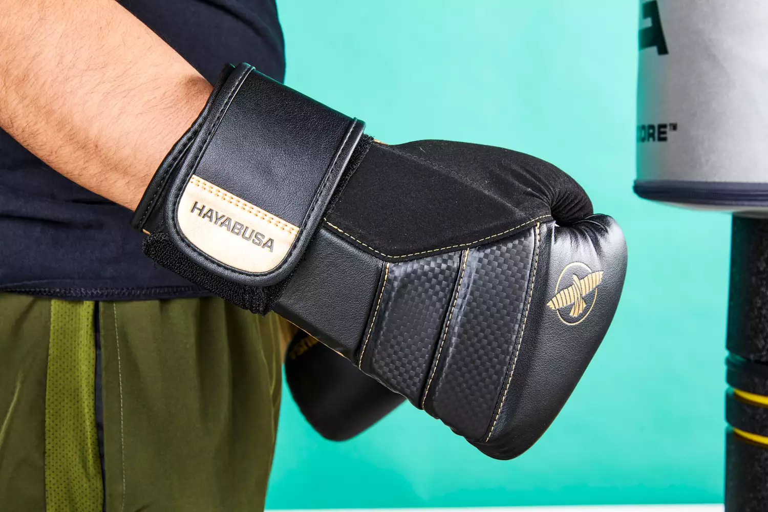 A person wearing Hayabusa T3 Boxing Gloves
