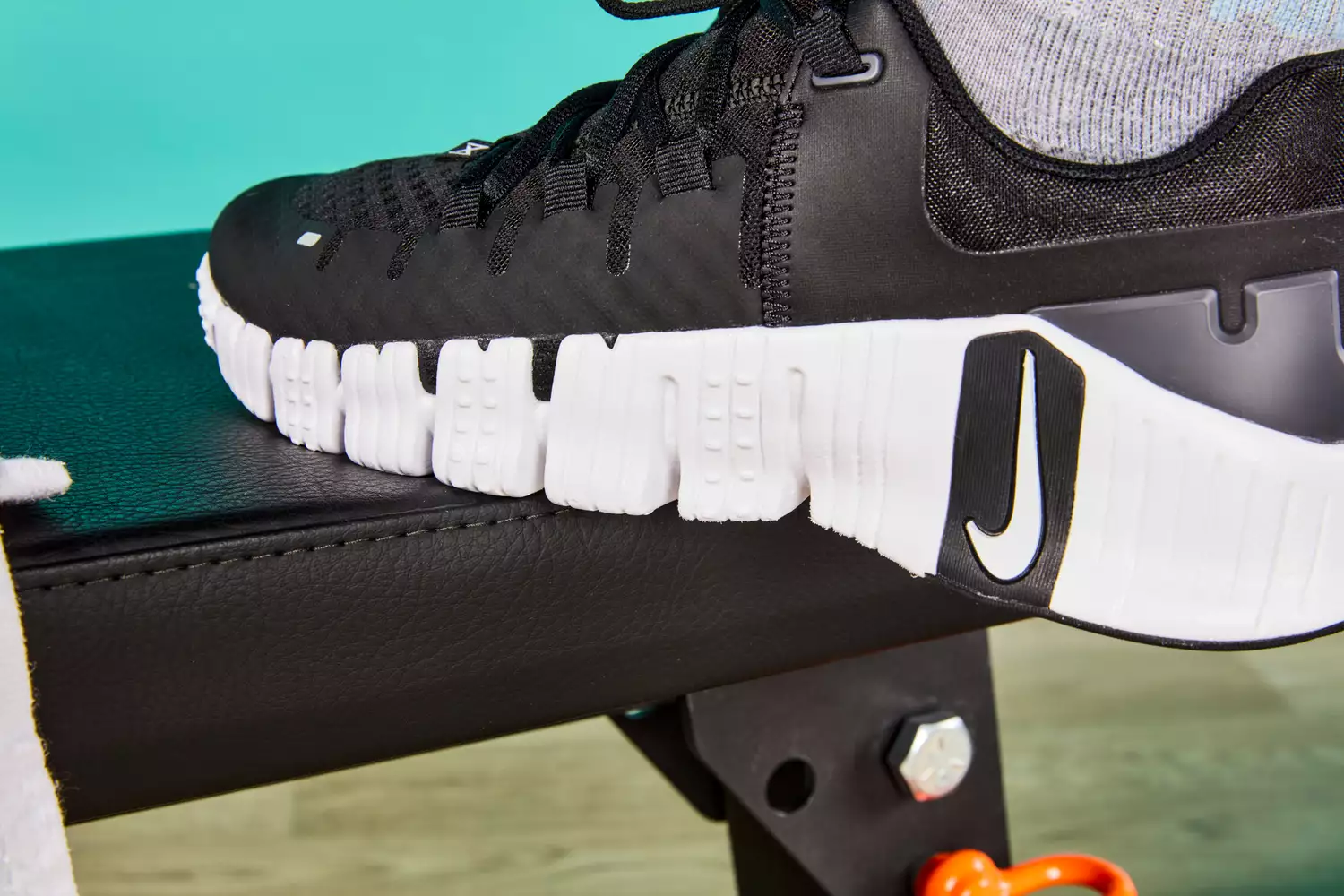 Person putting foor on bench wearing Nike Women's Free Metcon 5 Training Shoes