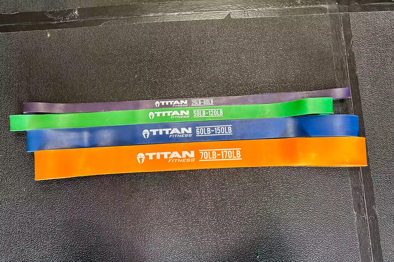 Titan Fitness bands laying on the ground