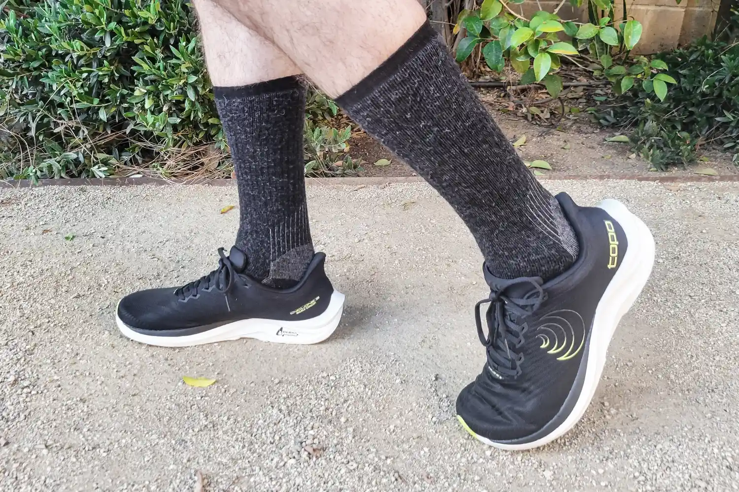 A side view of a person wearing the Topo Athletic Men's Cyclone 3 Road Running Shoes