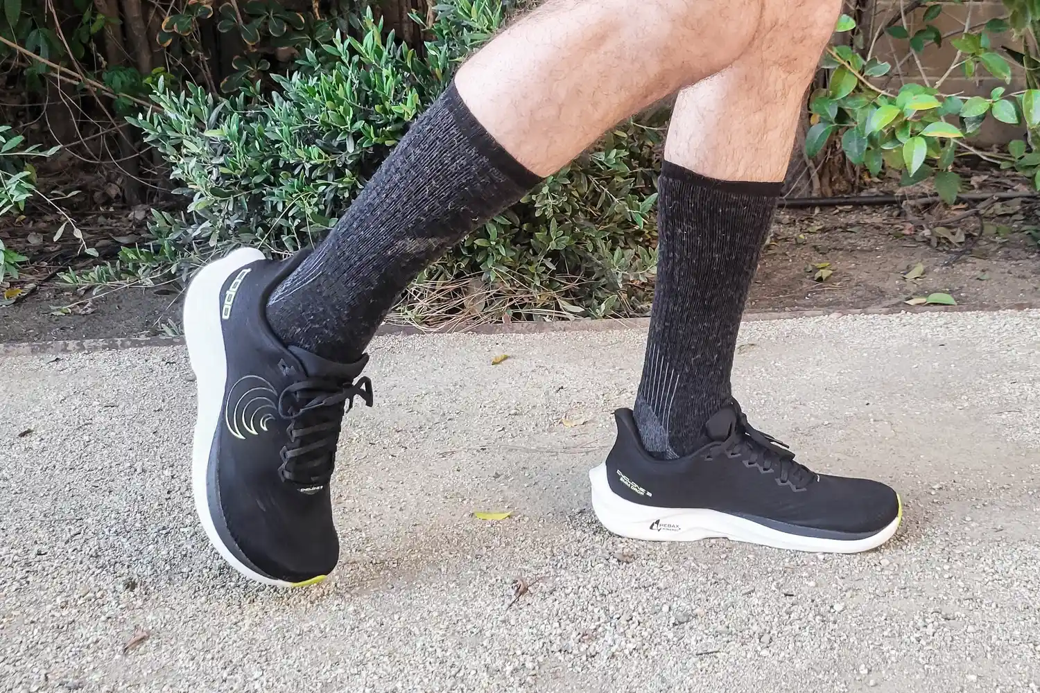 A side view of a person wearing the Topo Athletic Men's Cyclone 3 Road Running Shoes