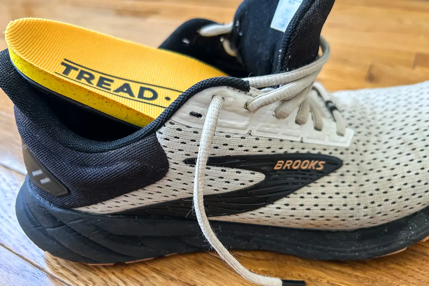 The Tread Labs Dash Insole partially inside a sneaker