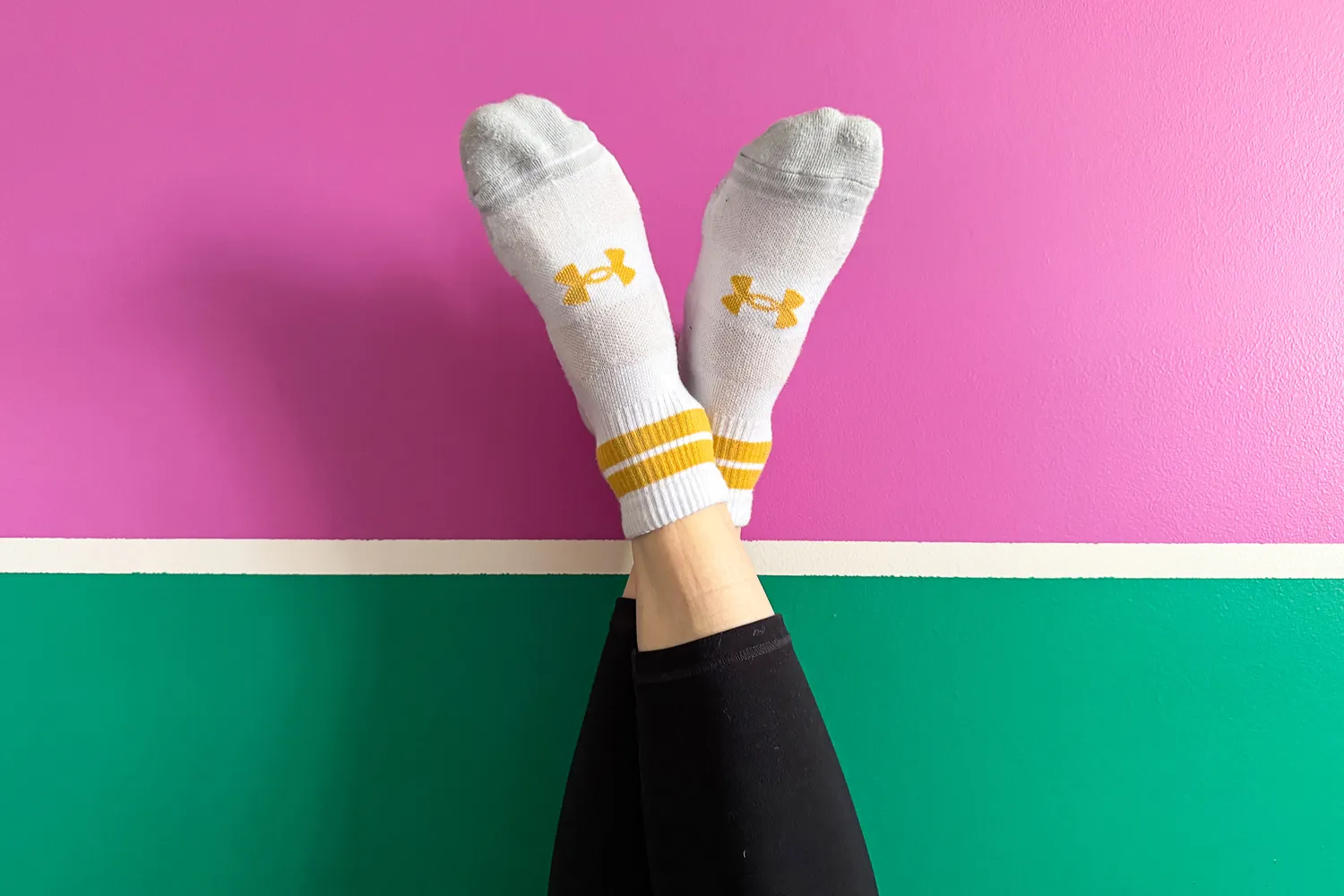 A person wears the Under Armour UA Performance Tech Socks inside