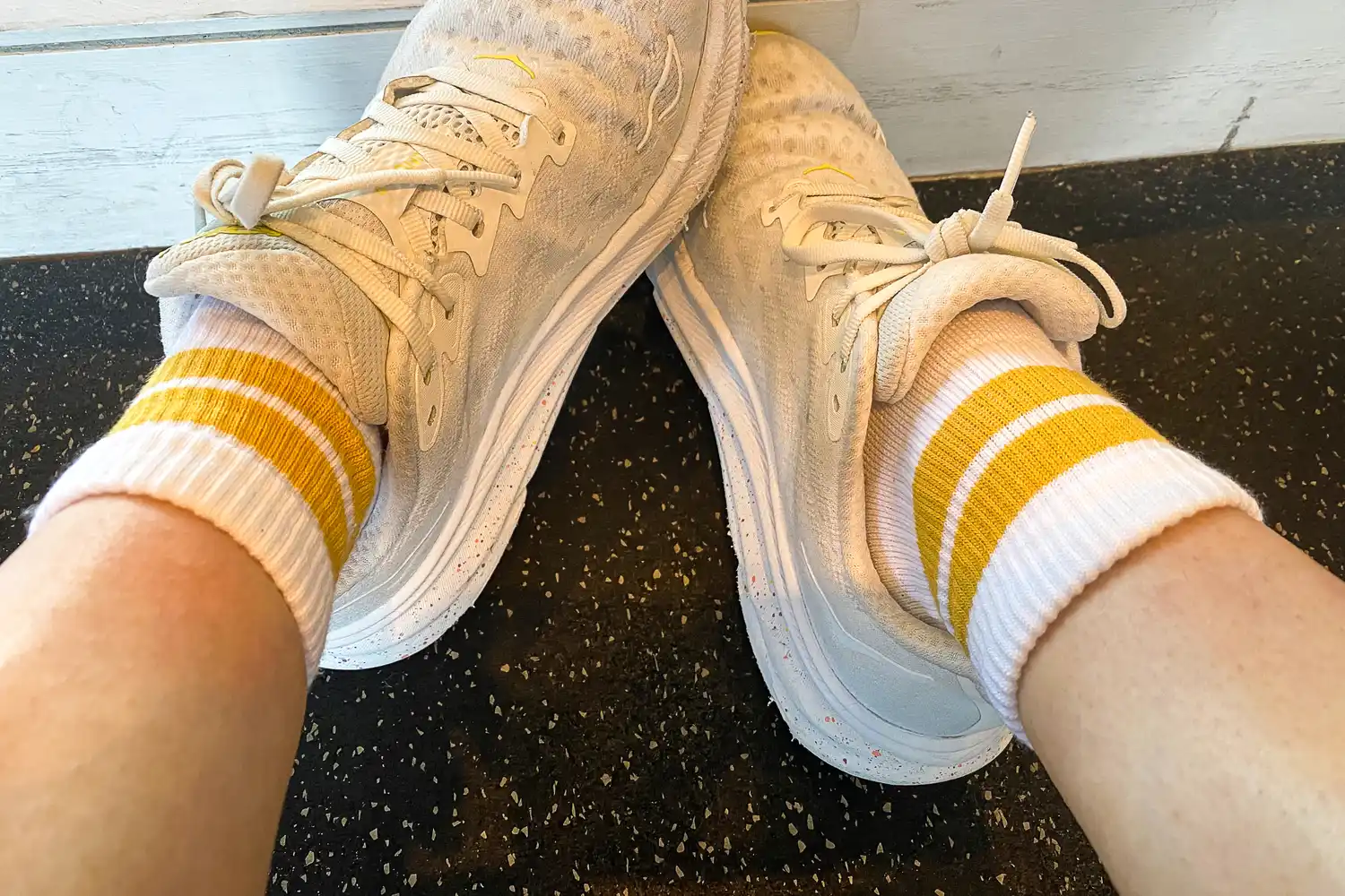 A person wears the Under Armour UA Performance Tech Socks and sneakers