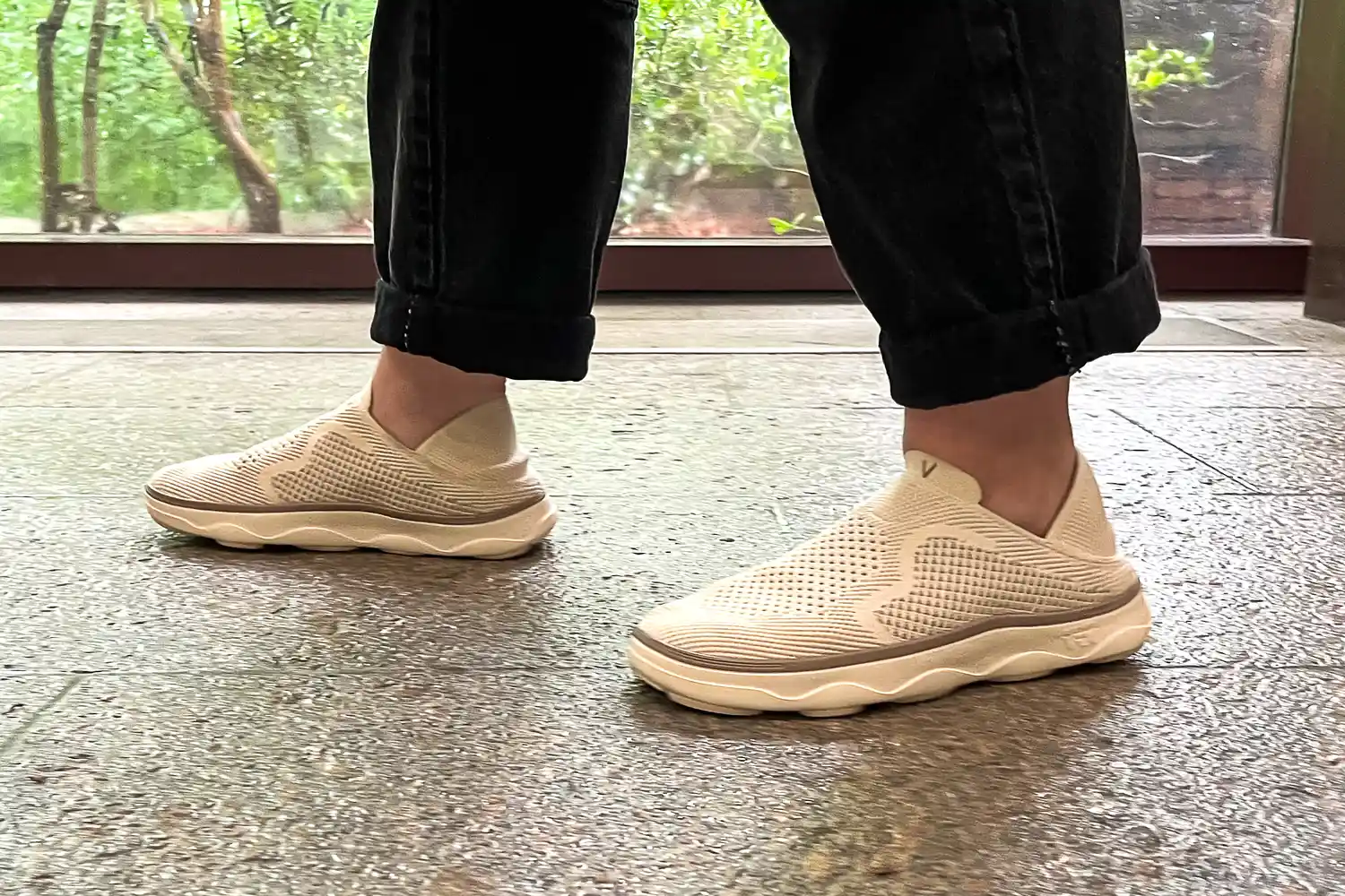 A person walks on a stone floor while wearing the Vionic Women's Sage RX Recovery Slip-On Shoes