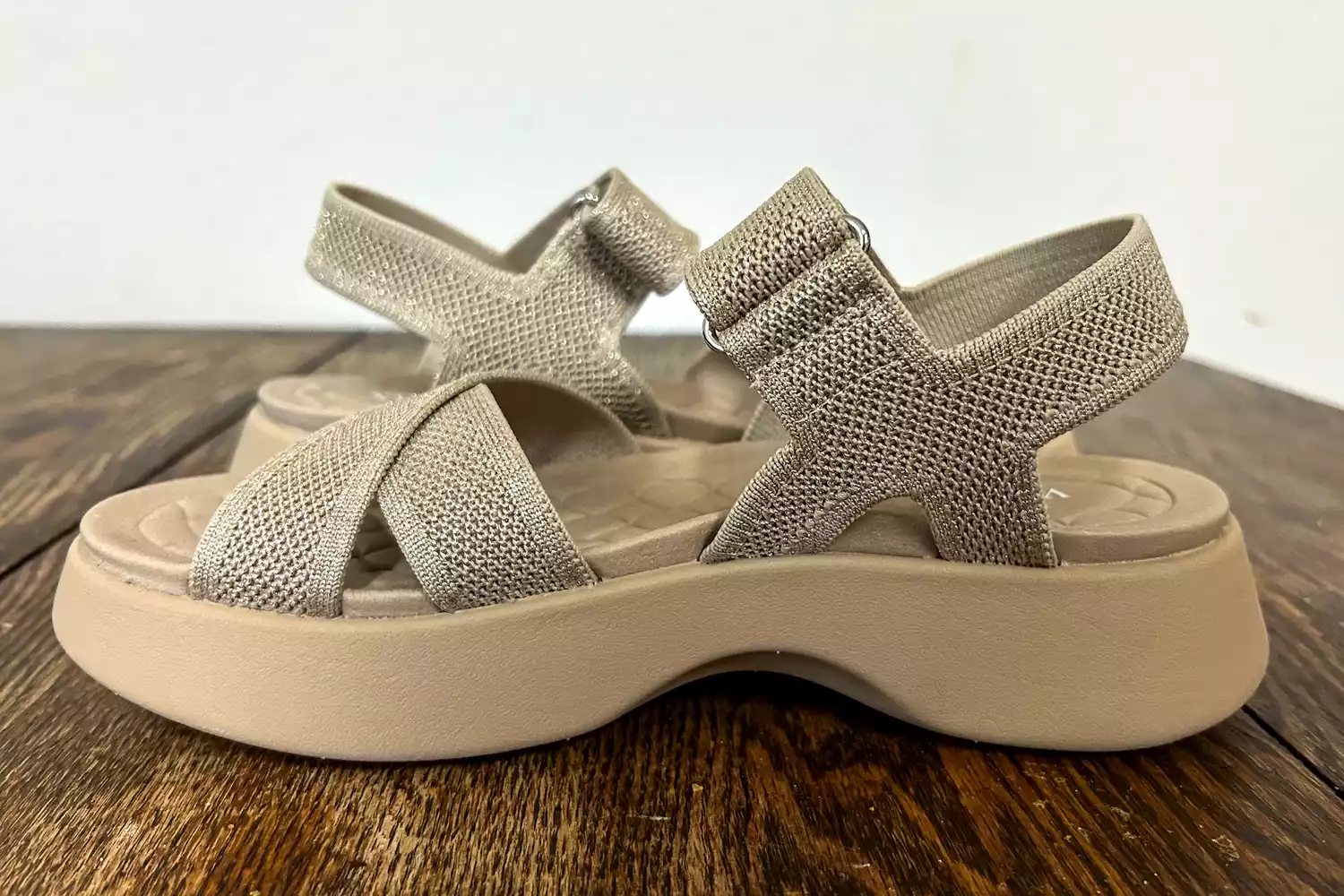 The side-view of the Vivaia Kiara Sport Sandals on wood