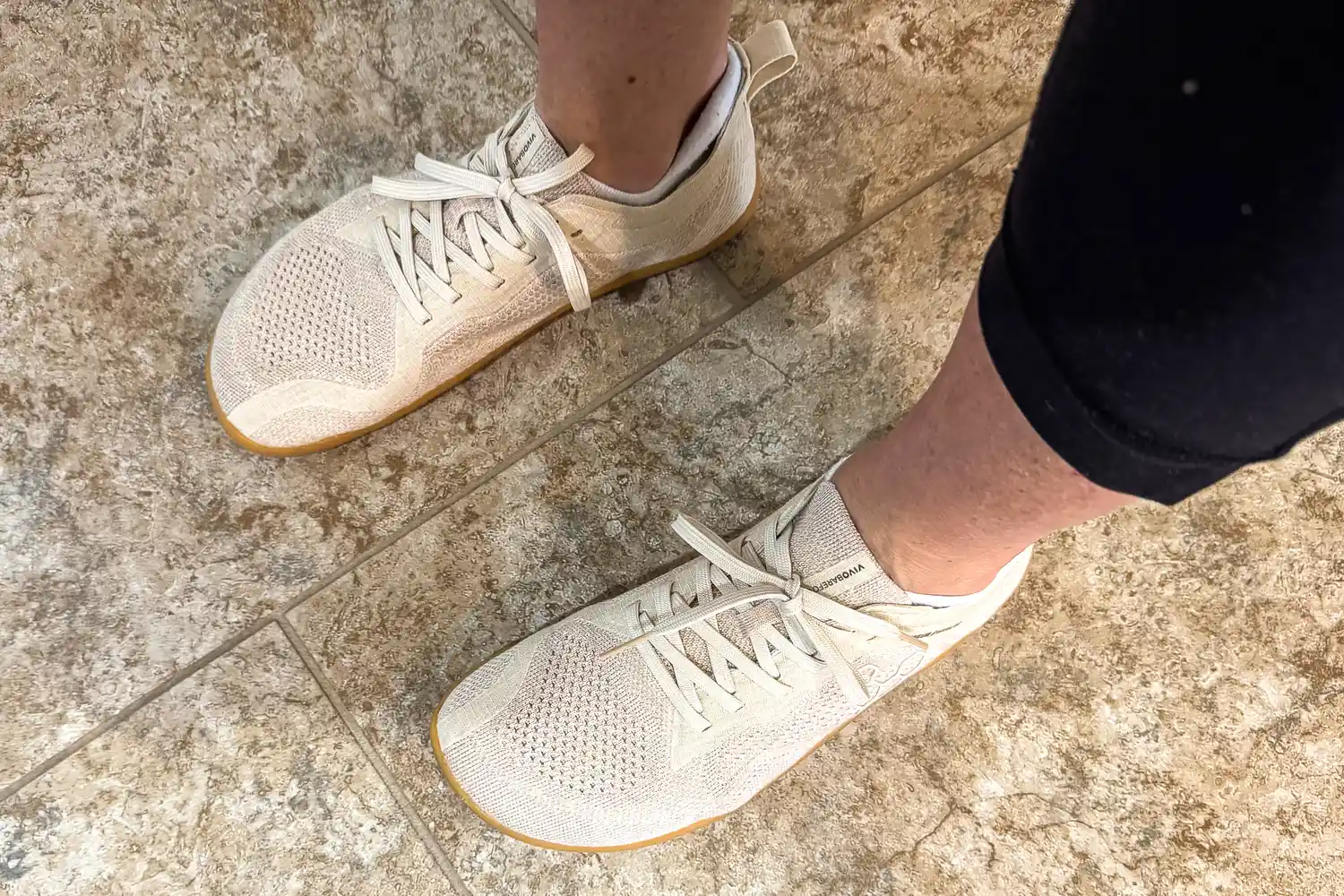 An overhead view of a person wearing the Vivobarefoot Women's Primus Lite Knit Natural Sneakers