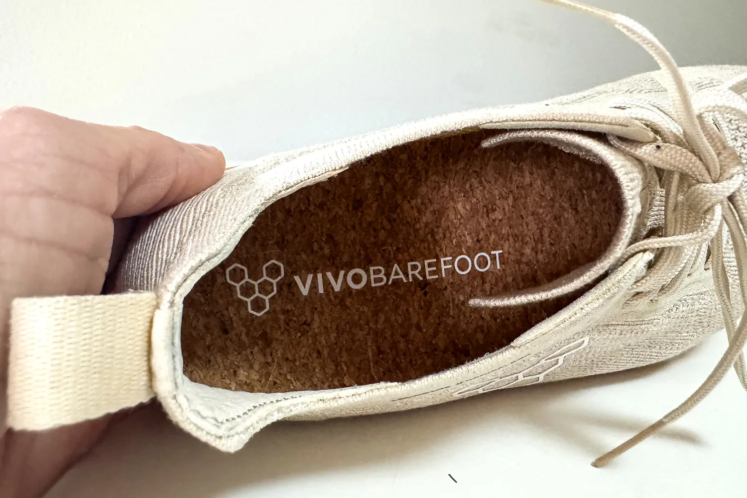 The brand name on the insole of the Vivobarefoot Women's Primus Lite Knit Natural Sneaker
