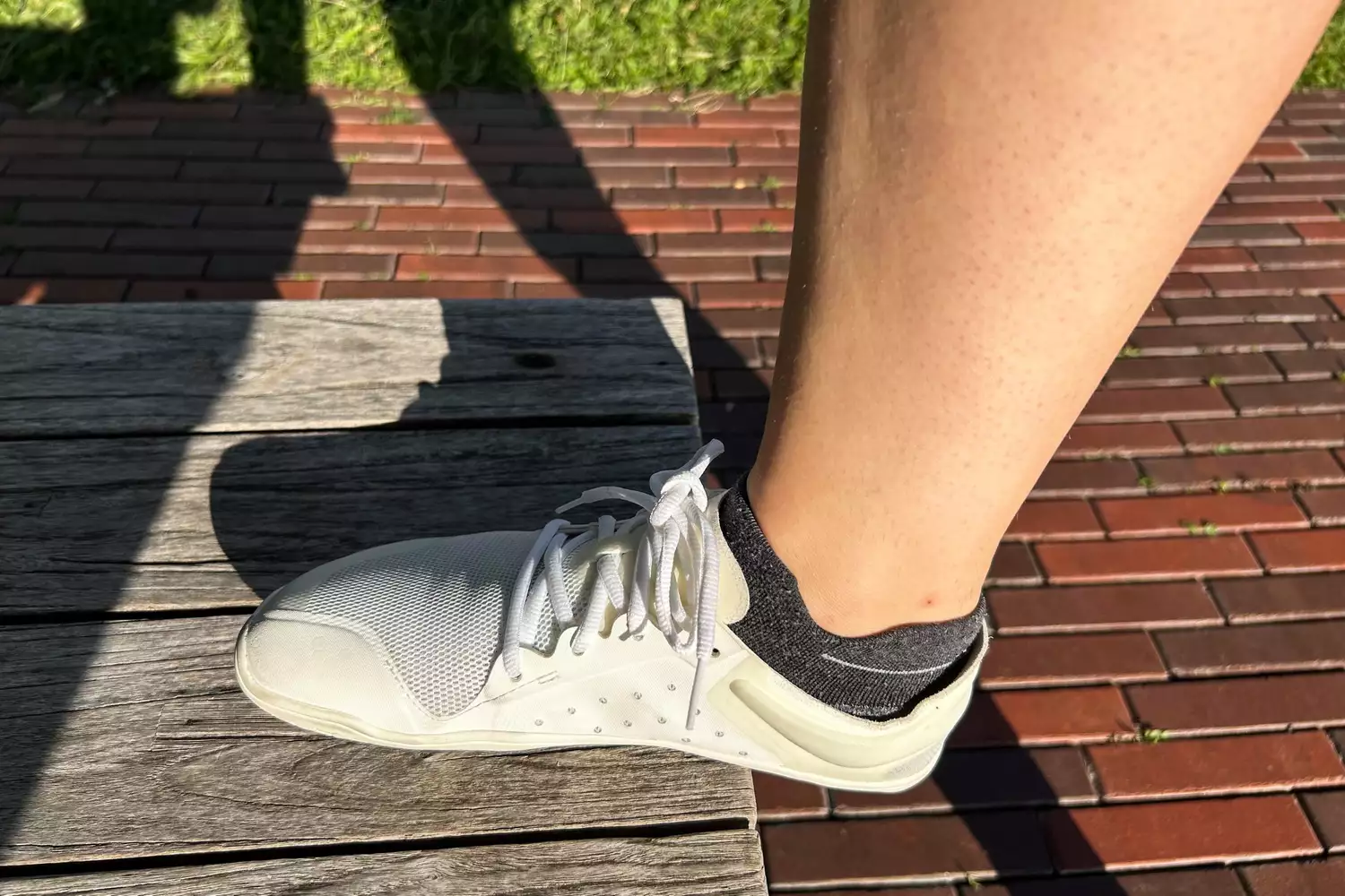 A person wears the Vivobarefoot Women's Primus Lite III Weightlifting Sneakers