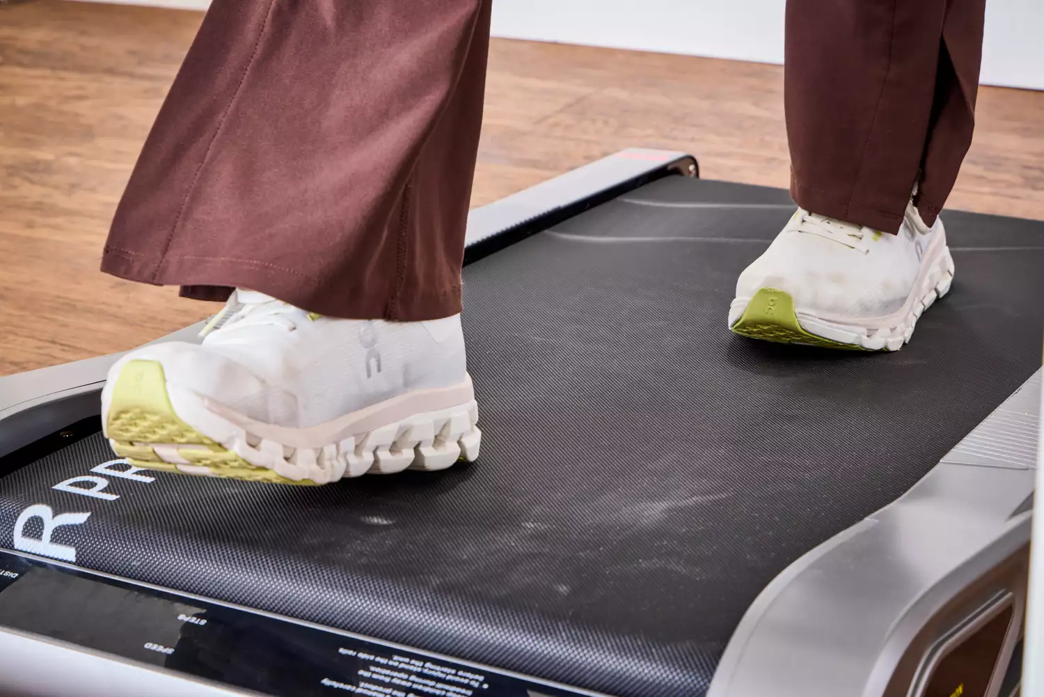 A close-up of feet walking on the Egofit Walker Pro-M1 Treadmill