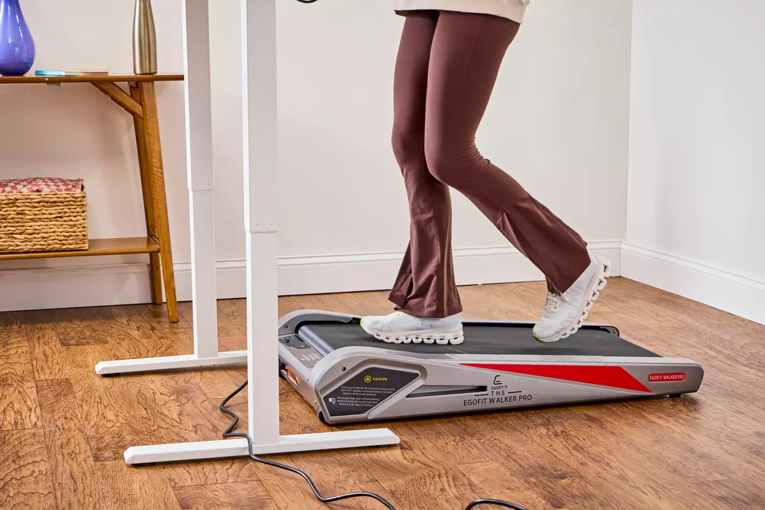 A person's legs walking on the Egofit Walker Pro-M1 Treadmill