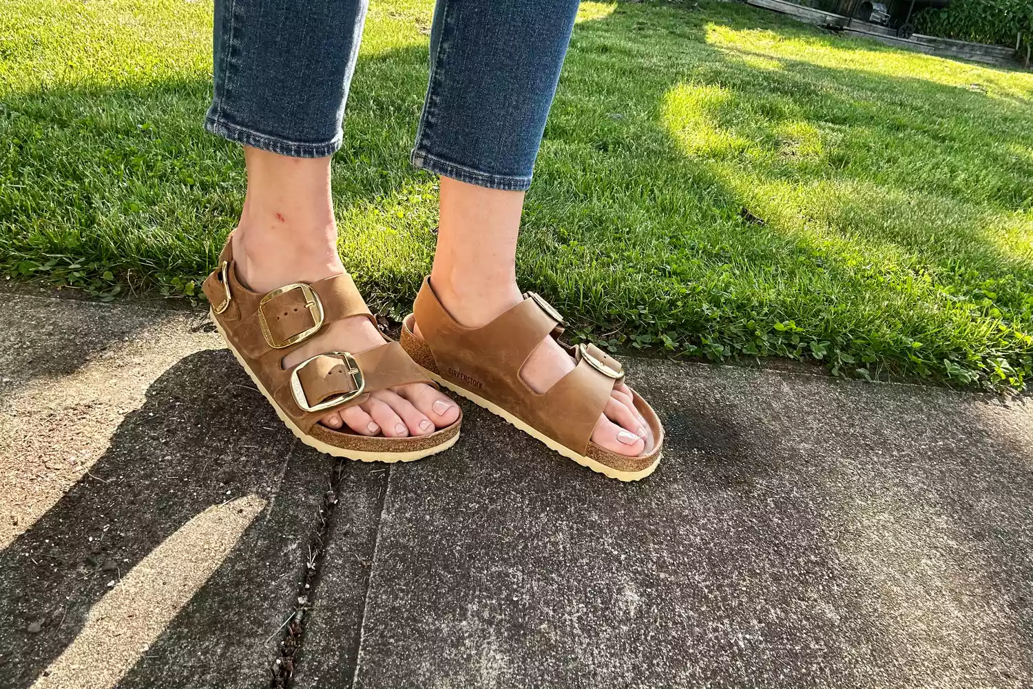 Birkenstock Milano Big Buckle Sandals being worn on sidewalk