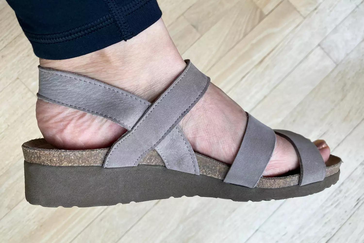 Foot wearing a NAOT Kayla Sandal
