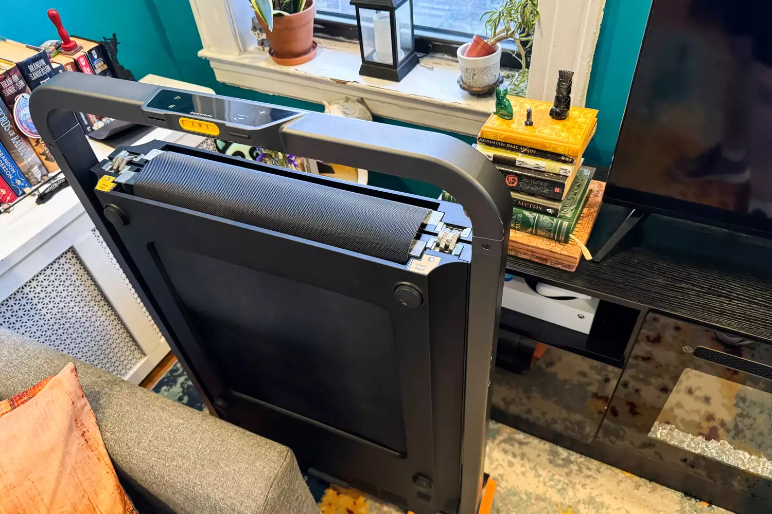 The WalkingPad MC11 Workout Treadmill folded vertically