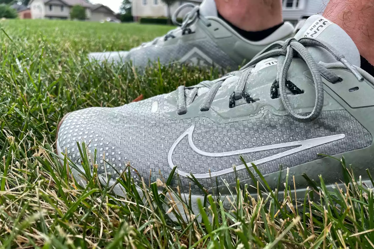 A person stands in grass while wearing the Nike Juniper Trail 2 GORE-TEX Men's Waterproof Trail Running Shoes