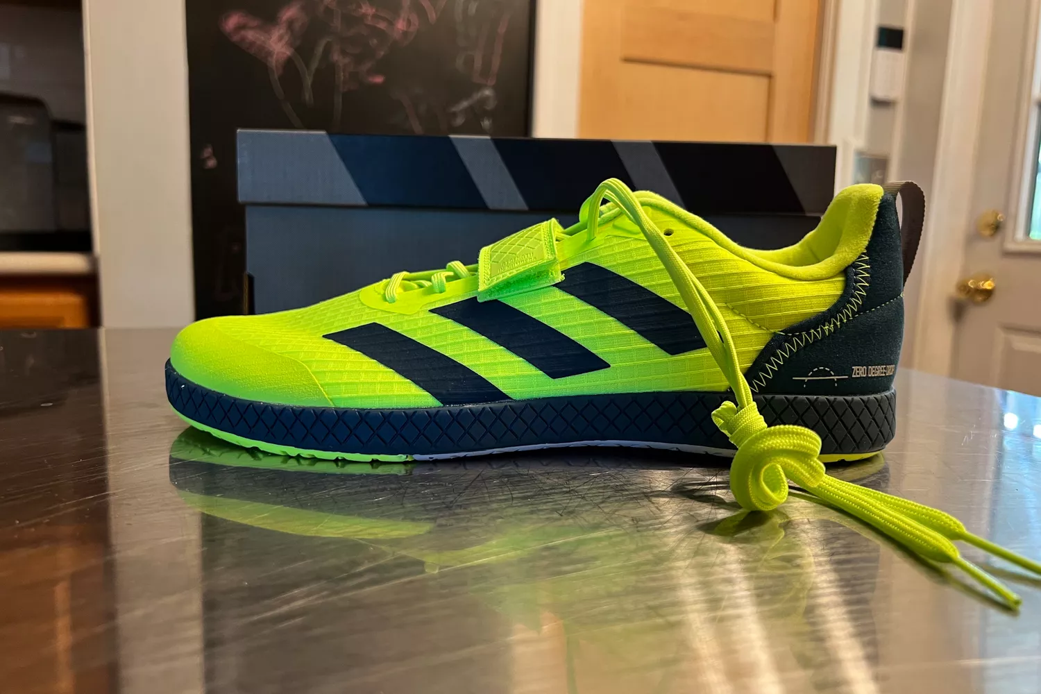 A side view of the adidas The Total Shoes Unisex Weightlifting Sneakers